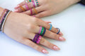 Model stacking gemstone rings and bracelets